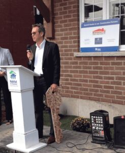 A Man Addressing Crowd at Costa Family Move-in Day in Toronto